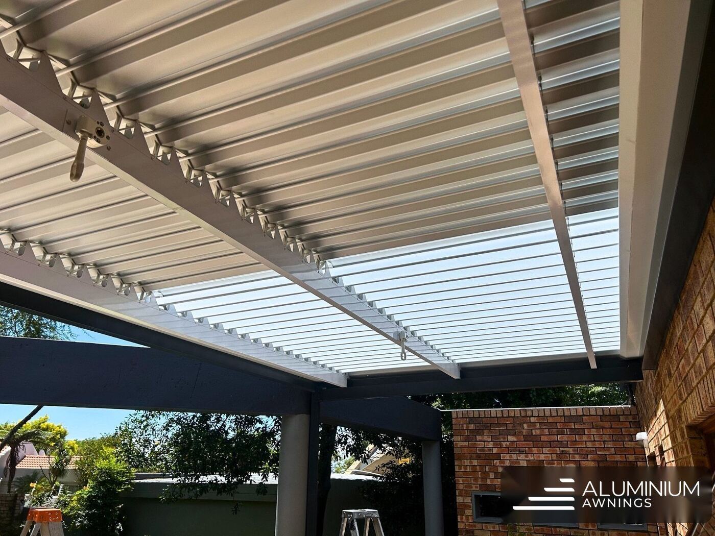 Manual louvre awning in charcoal frame with white louvre blades — Sandown, Cape Town