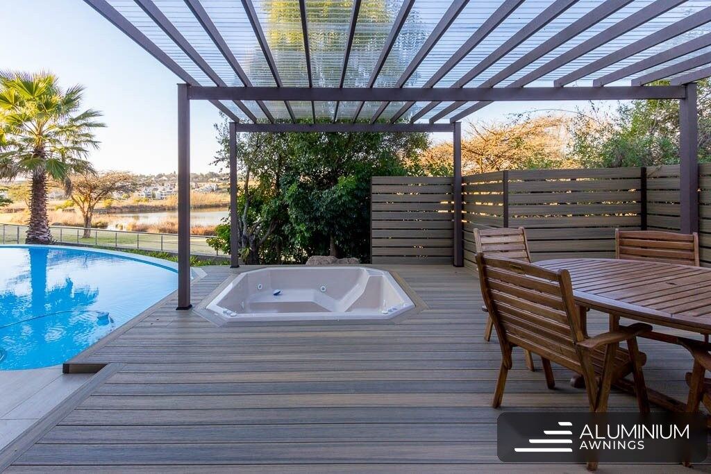 Composite pergola with polycarbonate roof over a Tokai pool deck