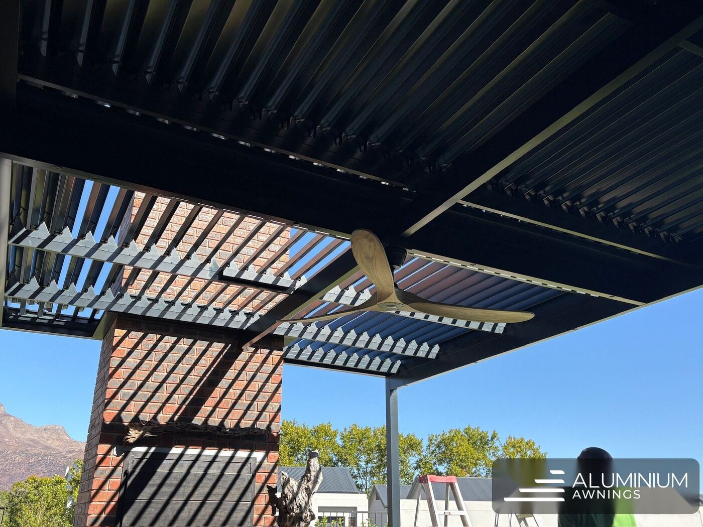 Motorised aluminium louvre roof with integrated ceiling fan, Cape Town